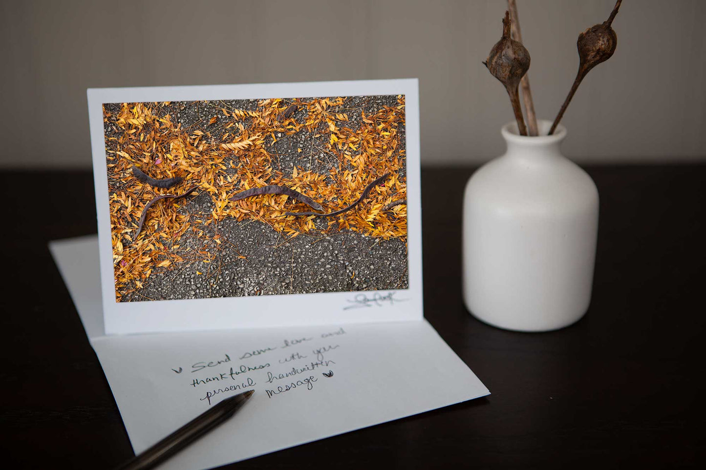 'Golden Passage' photo of catalpa beans on top of golden yellow and orange fall leaves Photo by Cambridge Ontario Photographer Laura Cook of Vision Photography