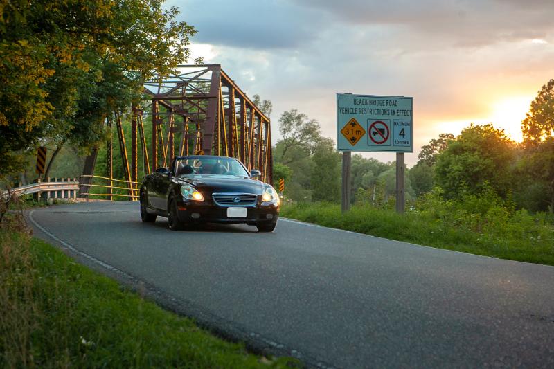 Photo of a Car Driving over Black Bridge in Hespeler at Sunset by Laura COok Vision Photography 